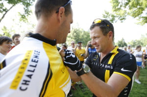 Lance Armstrong signs the jersey of a Livestrong team member in Carroll in 2011. (Register file photo)